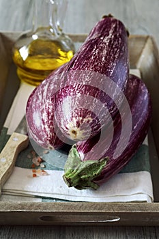 Three graffiti eggplants, pink salt, and olive oil