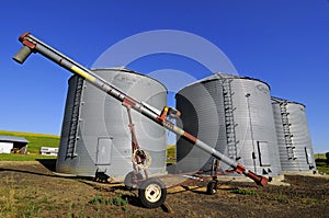 Three grain silos by the farmfield photo