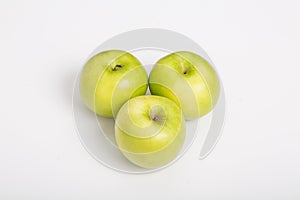 Three Granny Smith Apples on White Counter