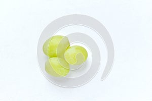 Three grapes close up on a white background