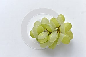 Three grapes close up on a white background