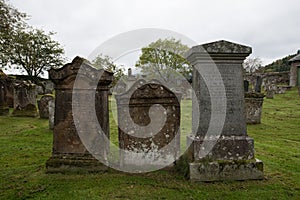 Three gravestones in a graveyard in Scotland