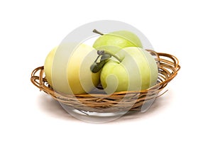 Three green apples in a basket on a white background