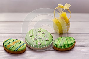 Three green easter cookies with a chik photo
