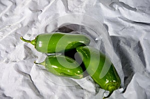 Three green hot jalapeno peppers