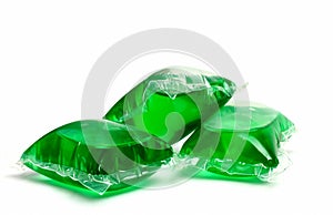 Three green laundry detergent capsules