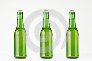 Three green longneck beer bottles 330ml, mock up.