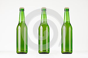Three green longneck beer bottles 500ml, mock up.