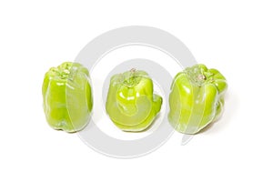 Three green peppers on isolated white