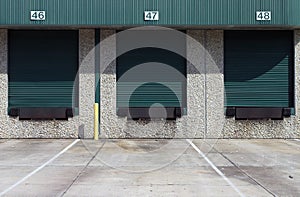 Three green warehouse loading bays