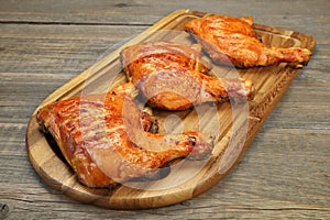 Three Grilled BBQ Chicken Leg Quarter On Wood Board