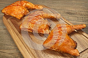 Three Grilled BBQ Chicken Leg Quarter On Wood Board