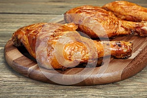 Three Grilled BBQ Chicken Leg Quarter On Wood Board