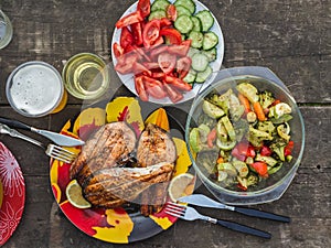 Three grilled salmon steaks with a side dish of baked vegetables