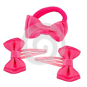 Three hairpins in the shape of a bright pink bow.