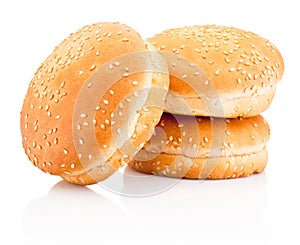 Three hamburger buns with sesame isolated on white background