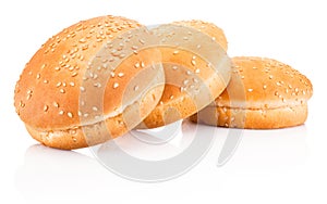 Three hamburger buns with sesame isolated on white background