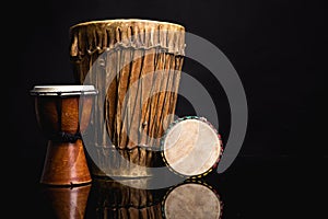 Three handmade Djembe drums isolated on black