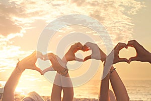 Three hands of a heart-shaped