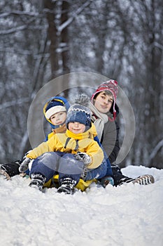 Three happy boys on sled