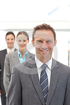 Three happy business people posing in a row