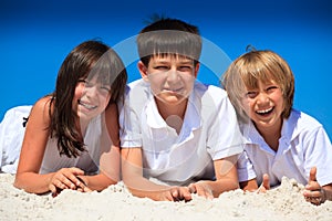 Three happy children on beach