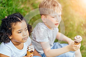 Three happy children eating ice cream near swimming pool at the day time. Concept healthy food. People having fun outdoors.