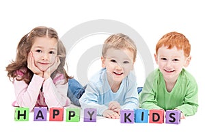 Three happy children with kids blocks