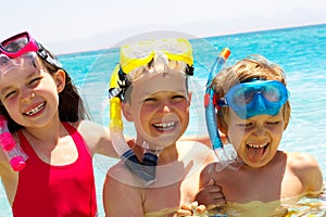 Three happy children in water