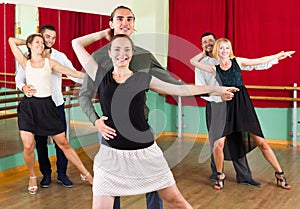 Three happy couples dancing tango