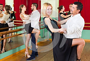 Three happy couples dancing tango