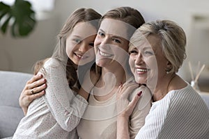 Three happy girls and women of different female family generations