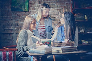 Three happy grills student learning together at home.