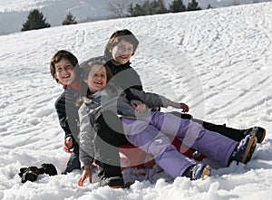 Three happy kids on snow during the summer holidays