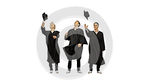 Three happy male graduates throwing mortarboards in the air and