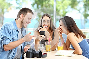 Three happy tourists laughing enjoying vacation