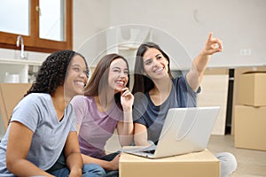 Three happy women planning decoration moving house