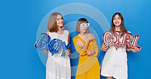 A three of happy women to have gender reveals envent, isolated blue background. Copy space.
