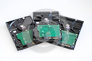 Three hard drives for computer systems are located on a light background