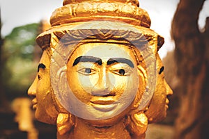 Three heads of golden Buddha statue in monesary in Siem Reap, Cambodia