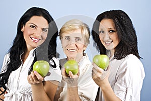 Three healthy beauty women giving you apples