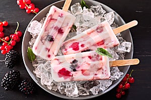 Three healthy frozen yogurt and berry iced lollies