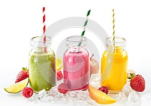 Three healthy smoothies with fresh tropical fruit