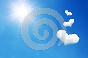 three heart shaped cloud on blue sky with sunshine