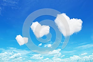 three heart shaped clouds on blue sky