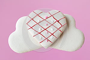 Three heart shaped cookies on pink background