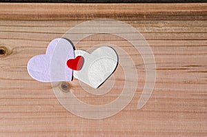 Three hearts on wooden background. Valentine Day, family, wedding love concept