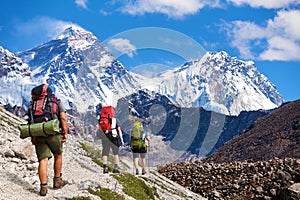 three hikers and mounts Everest Lhotse from Gokyo valley photo