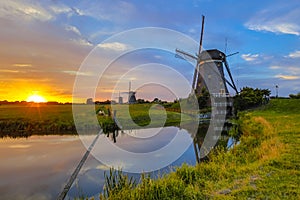 Three historic wooden windmills in a row