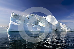 Three holes iceberg floating in Disko Bay